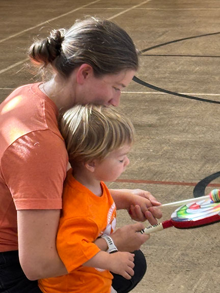 Parent and child playing drum together